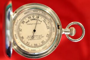 Image of dial of silver hunter cased pocket barometer in silver case by Albert Thomas Oliver, retailed by Aitchison & Co c1905