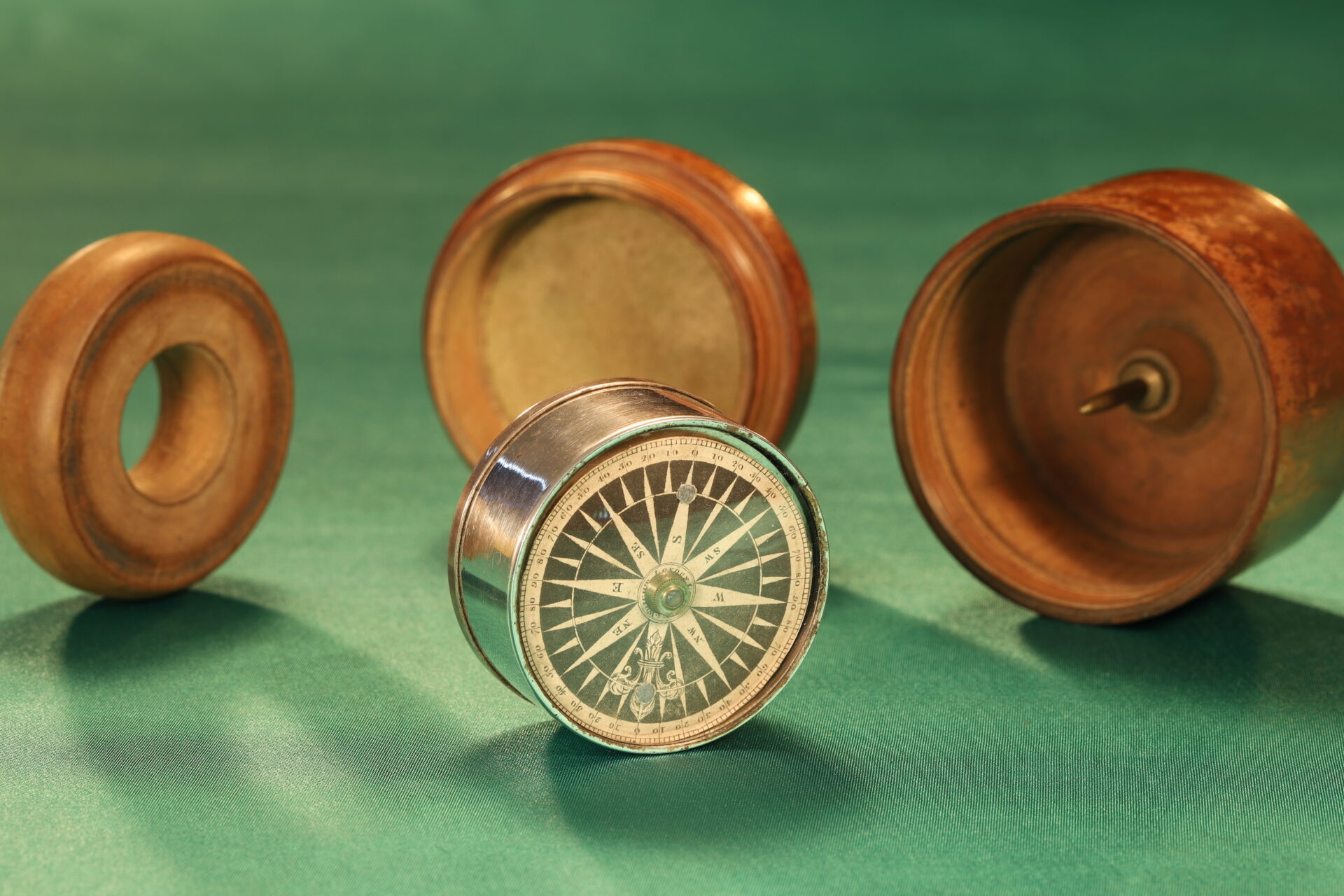 Image of disassembled Gregory & Wright Gimballed Mariners Compass c1785 showing compass from lefthand side